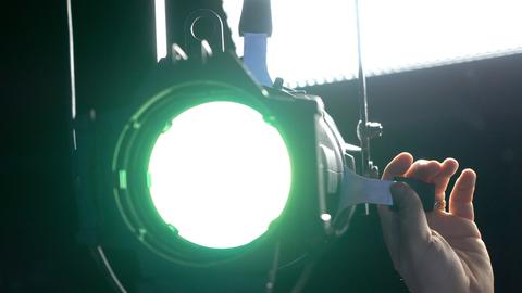 spotlight with green gel being focussed