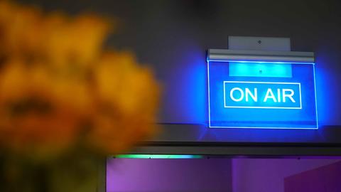 On Air warning sign illuminated in a montage photo - Casey Smerczynski