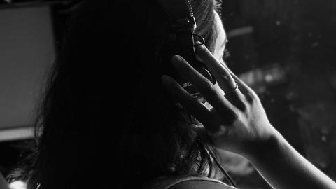 back of woman's head (Binita) adjusting headphones - photo Casey Smerczynski