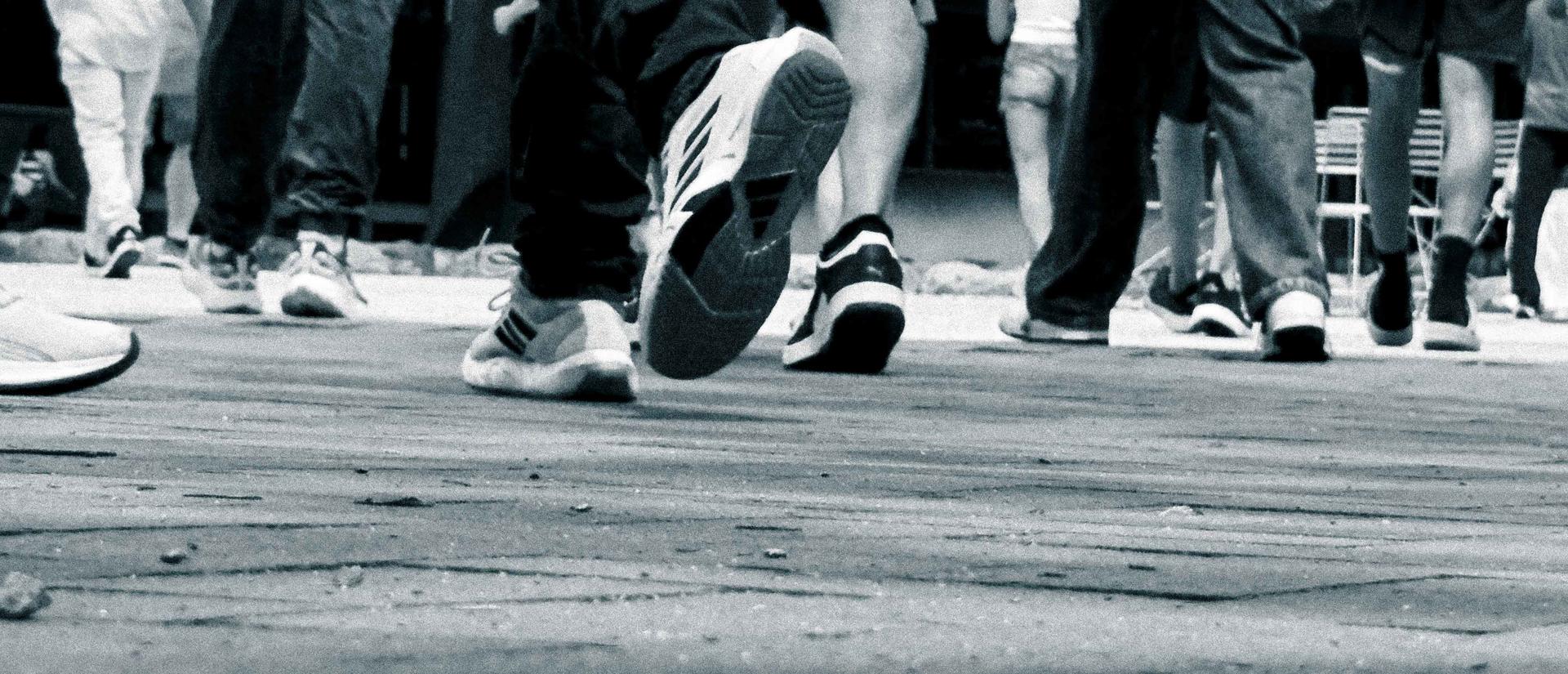 herd of feet crossing Science Center Plaza in black and white - photo Casey Smerczynski 