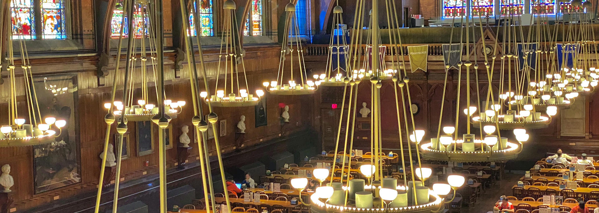 Harvard's Annenberg Hall serves as DCE's HSS cafeteria and was built in 1874 as a student commons, with long wood tables, stained glass windows and chandeliers. Photo by Rich Hinds.